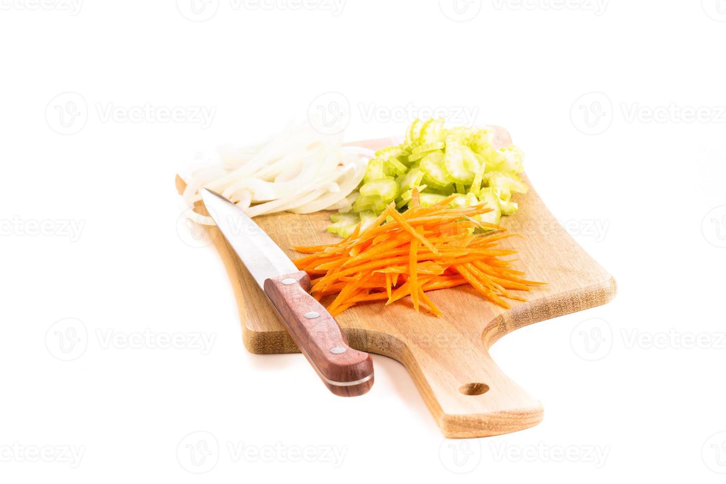 Carrot, onion and celery on a cutting board photo