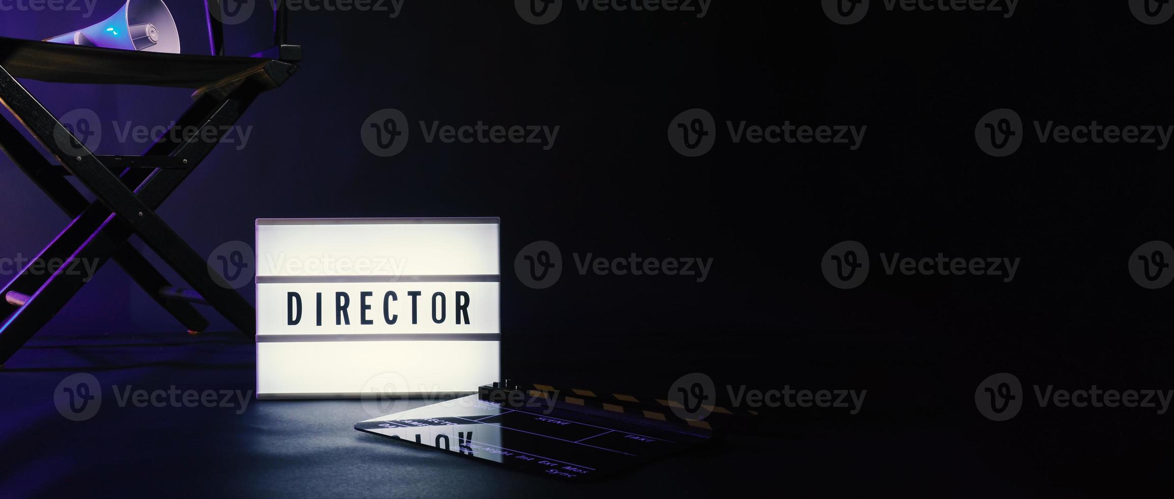 Director chair with cinema lightbox sign Director text on it and clapperboard megaphone photo