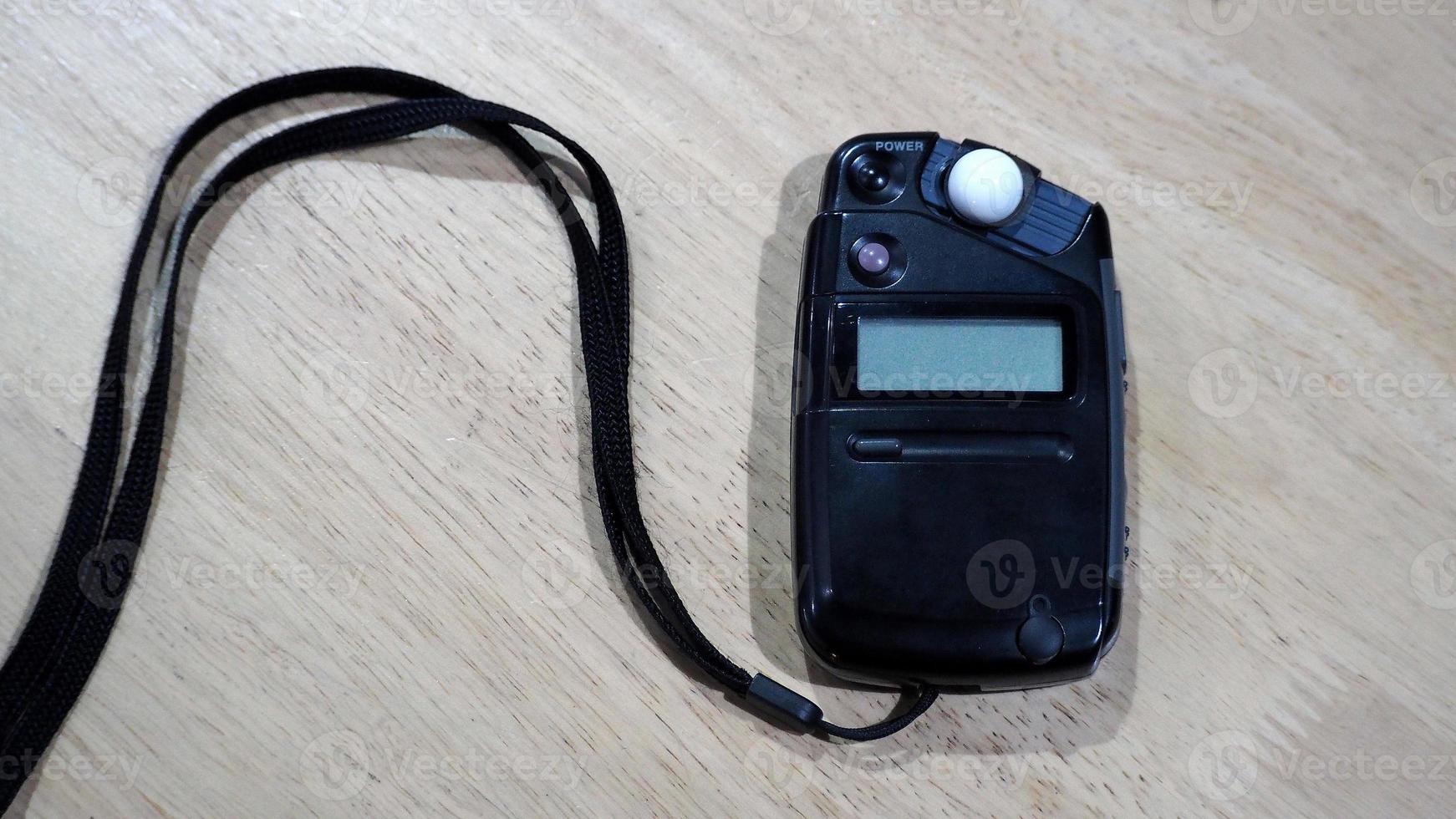 Light meter black color on the wood texture table and top view angle. photo