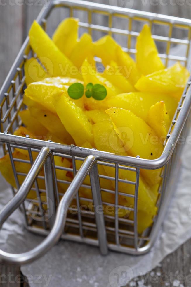 Homemade french fries in a frying basket photo