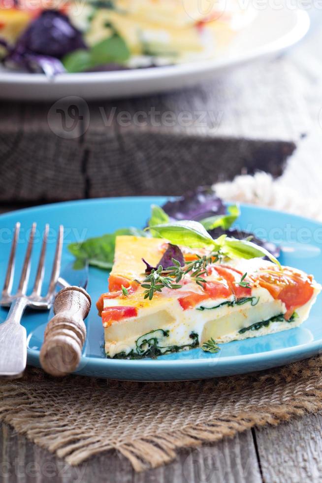 Frittata with tomatoes, herbs and potatoes photo