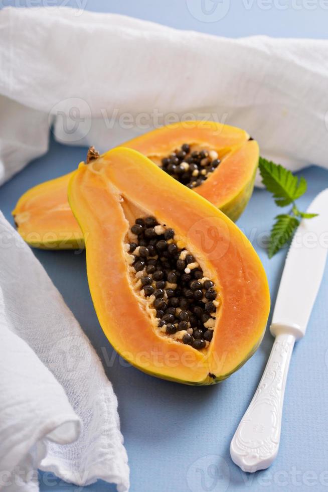 Cut papaya on a blue table photo