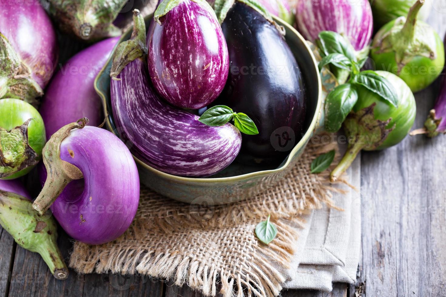 Eggplants of different variety on the table photo