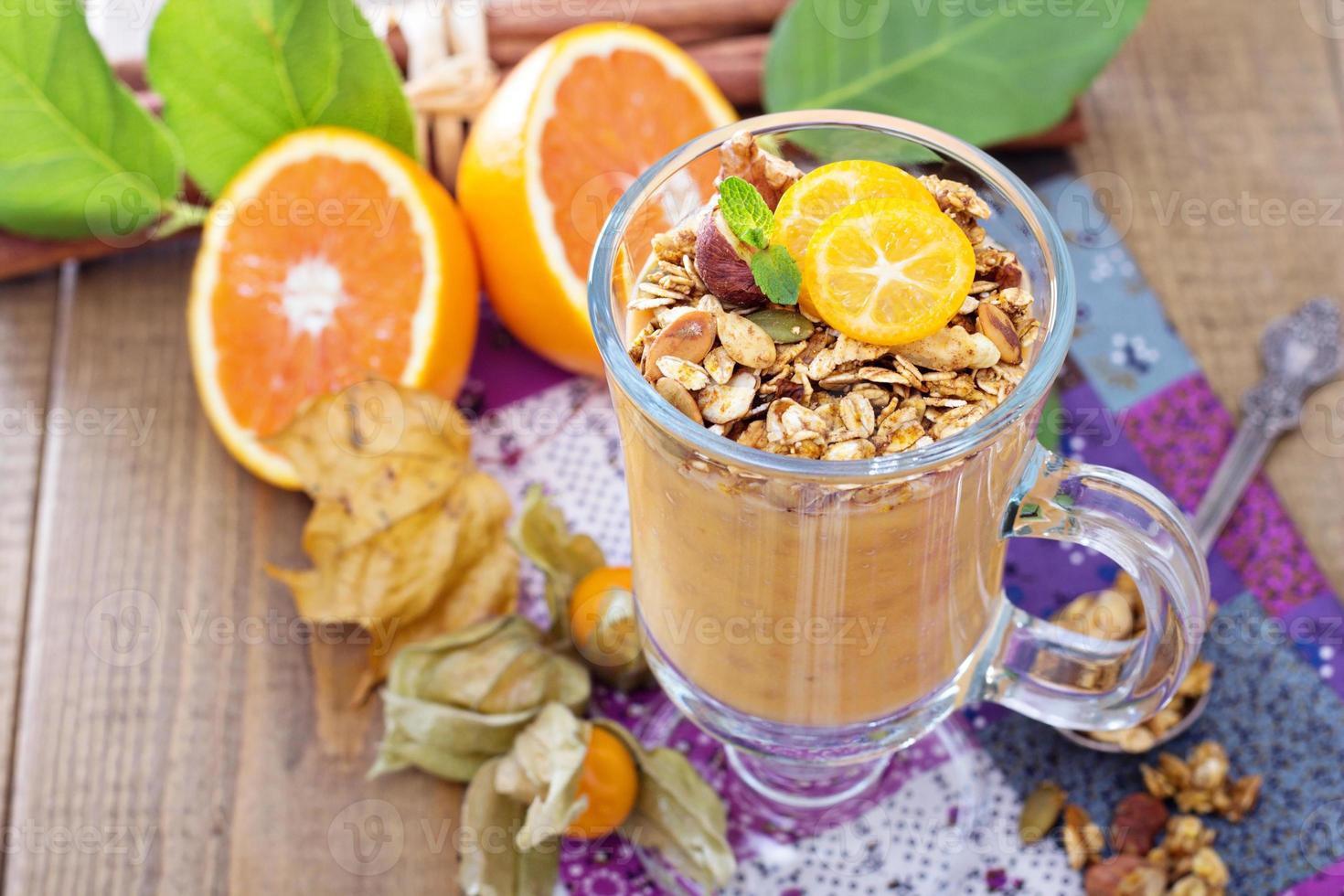 Pumpkin smoothie with granola on top photo