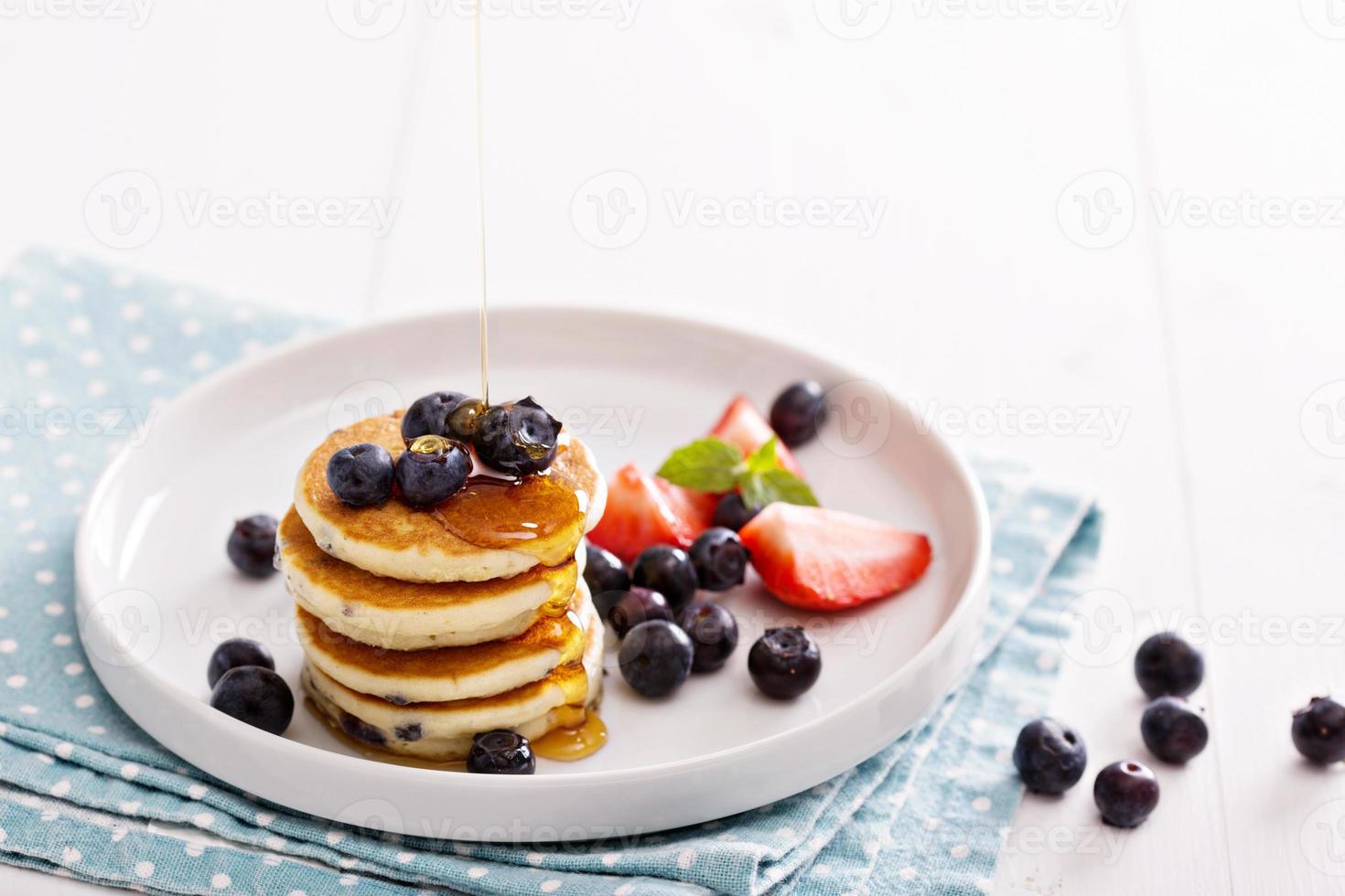 Stack of small pancakes with berries photo