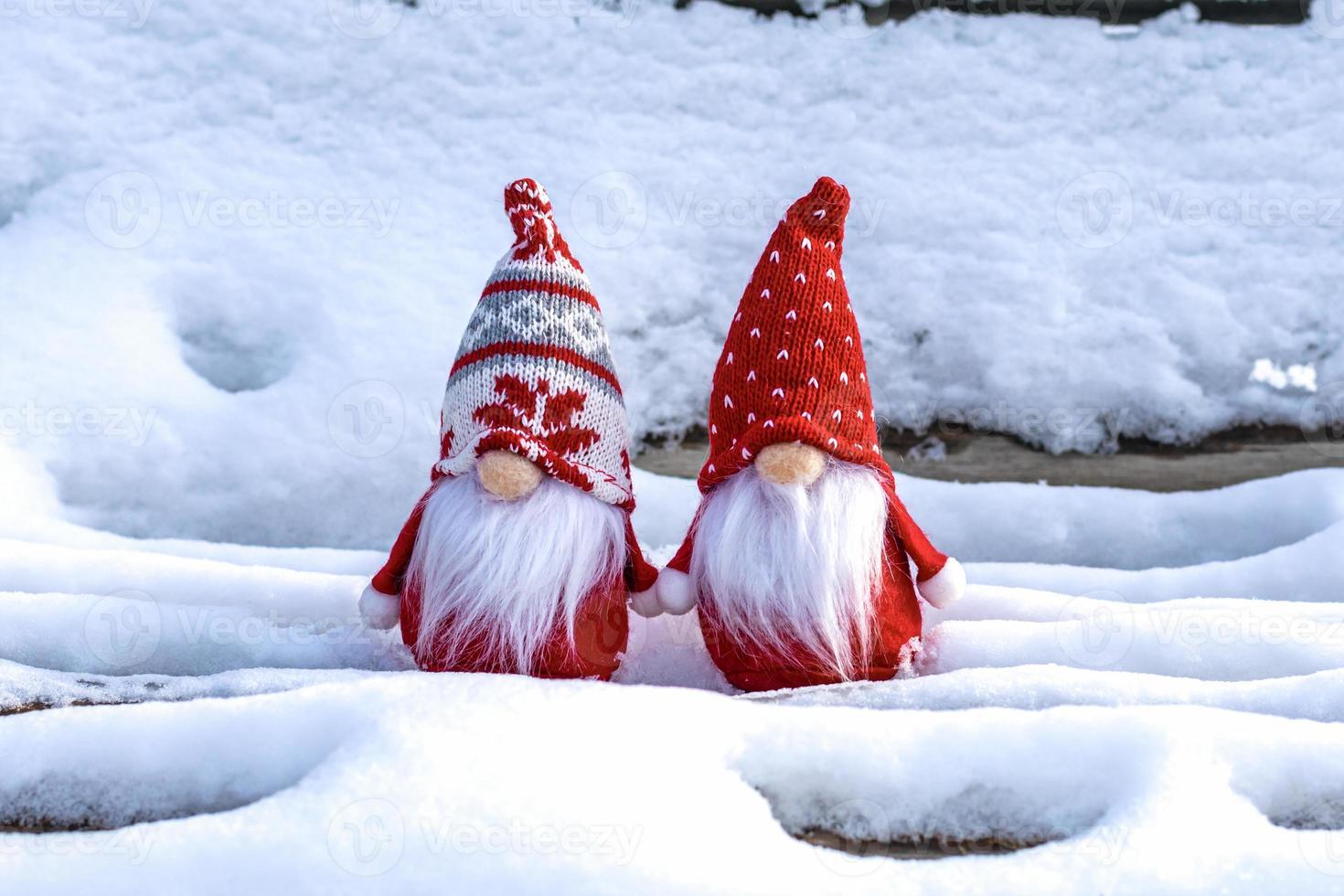 Christmas holiday card Cute scandinavian gnomes with red hat and white beard on snowy winter bench Fairytale snowfall Wintertime Hello December, January, February concept Happy New Year, Christmas photo