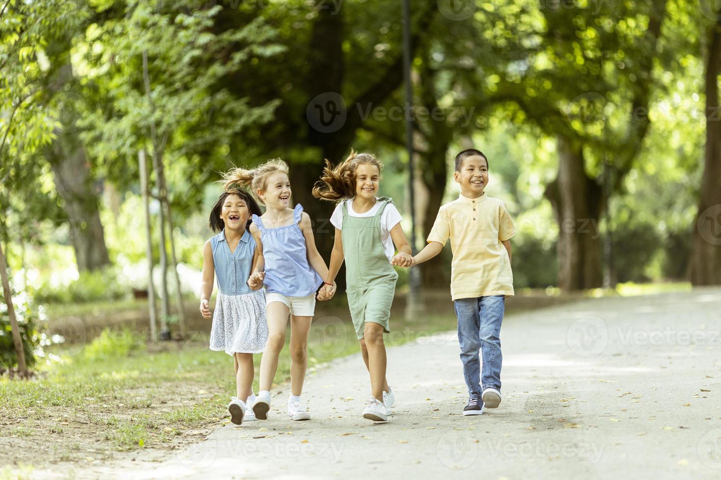 Group of asian and caucasian kids having fun in the park photo