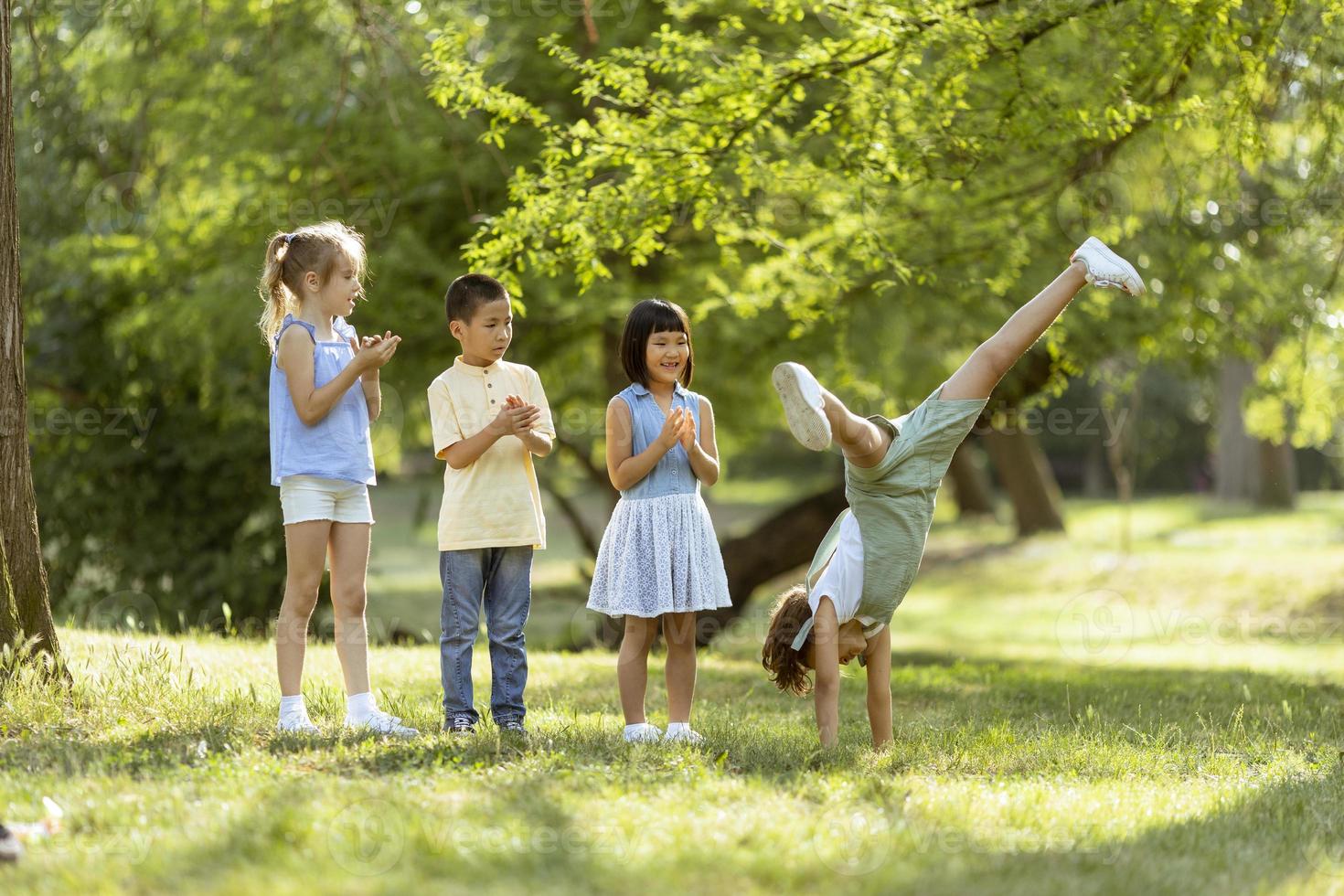 Group of asian and caucasian kids having fun in the park photo