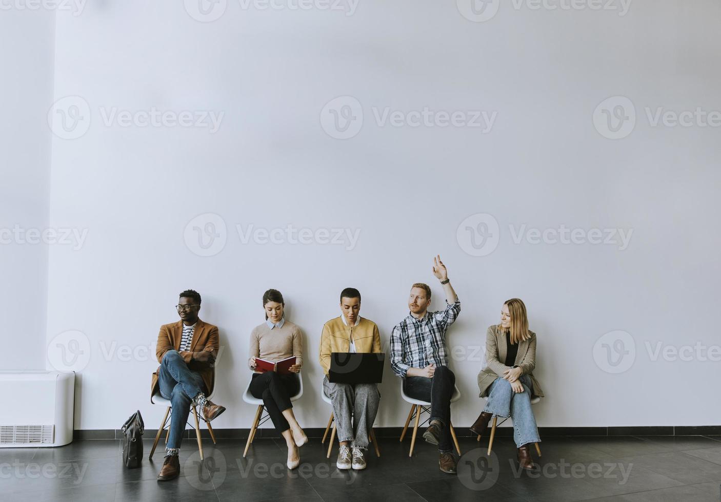 Group of bored people waiting for the job interview photo