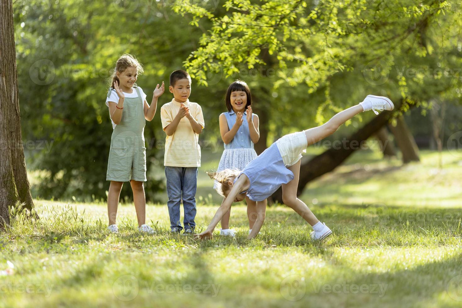 Group of asian and caucasian kids having fun in the park photo