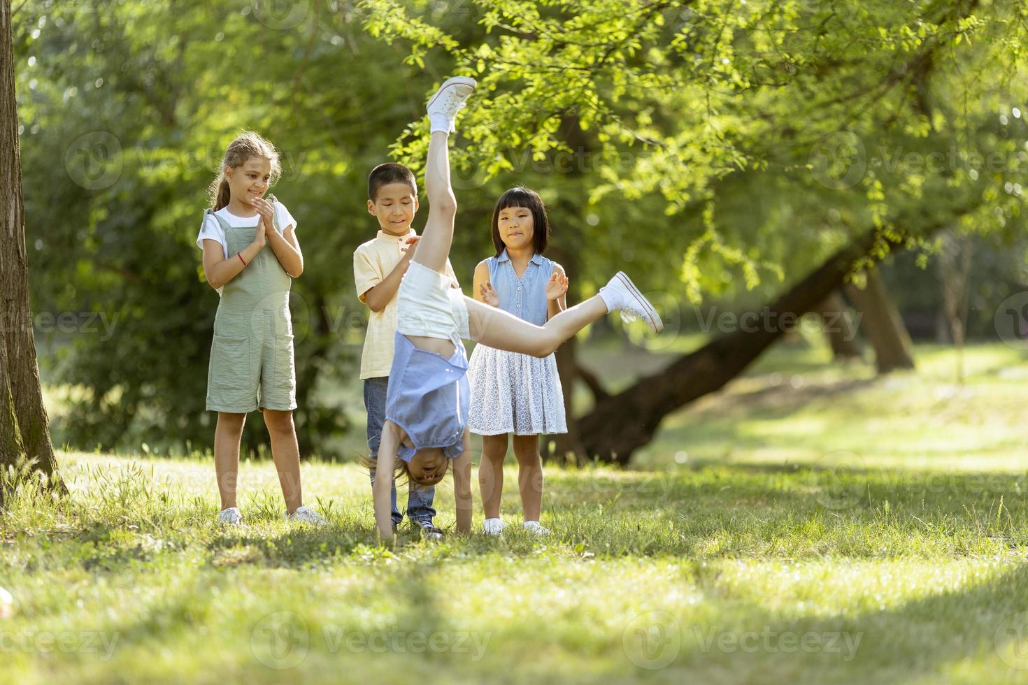 Group of asian and caucasian kids having fun in the park photo