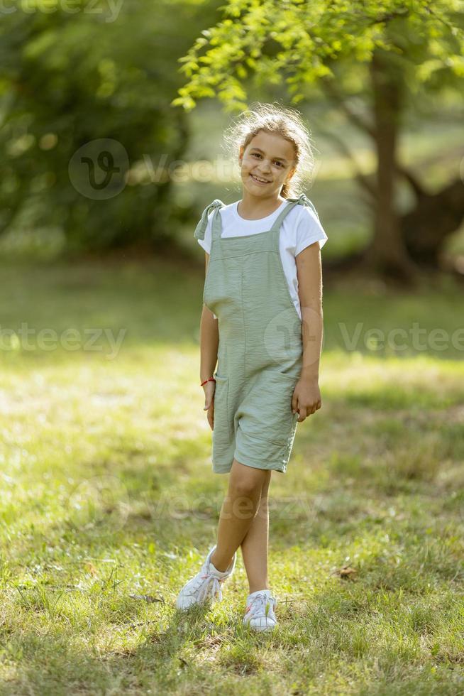 Cute little girl standing in the park photo