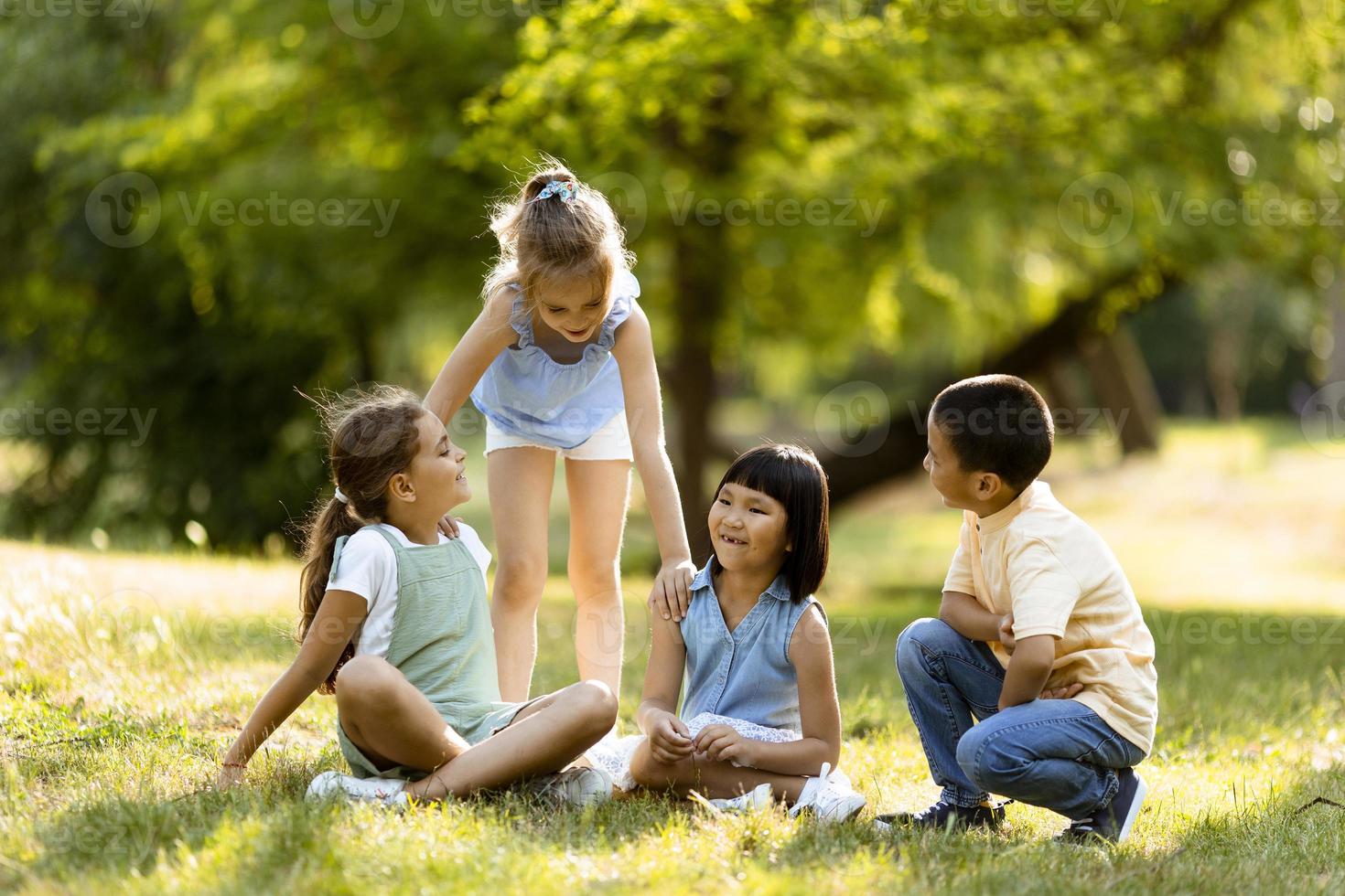 Group of asian and caucasian kids having fun in the park photo