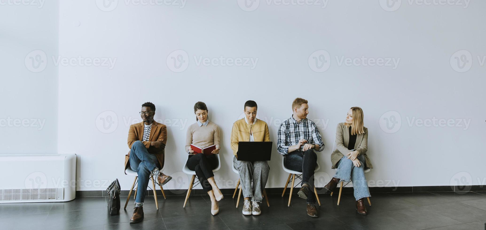 Group of bored people waiting for the job interview photo