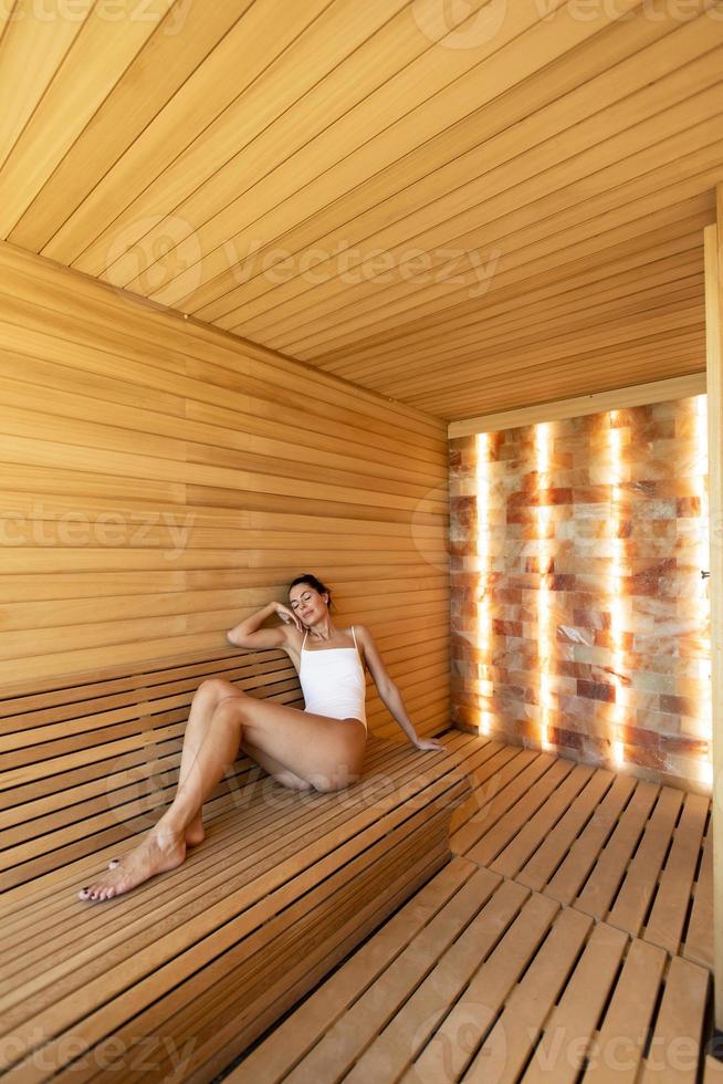 Young woman relaxing in the sauna photo