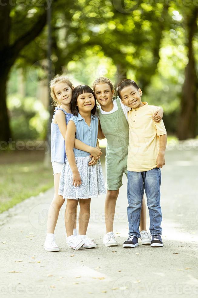 Group of asian and caucasian kids having fun in the park photo