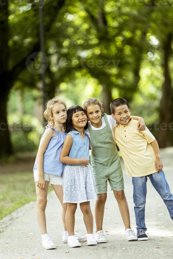 Group of asian and caucasian kids having fun in the park photo