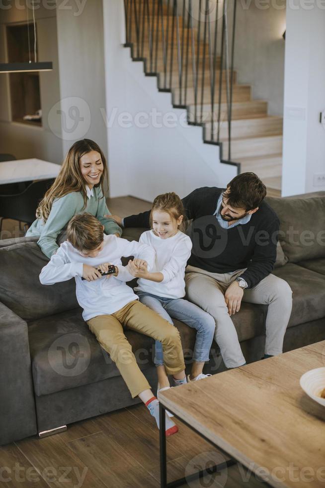 Siblings fighting over TV remote control at home photo