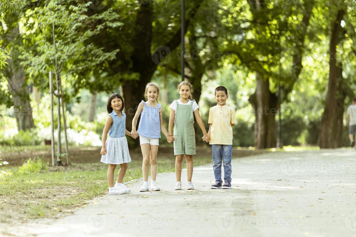 Group of asian and caucasian kids having fun in the park photo