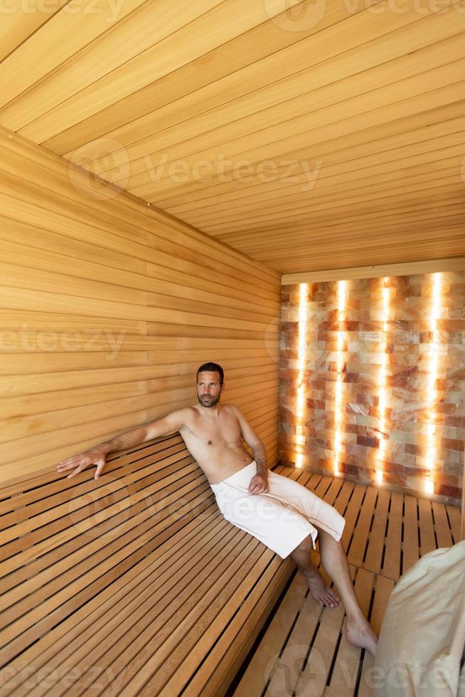 Young man relaxing in the sauna photo