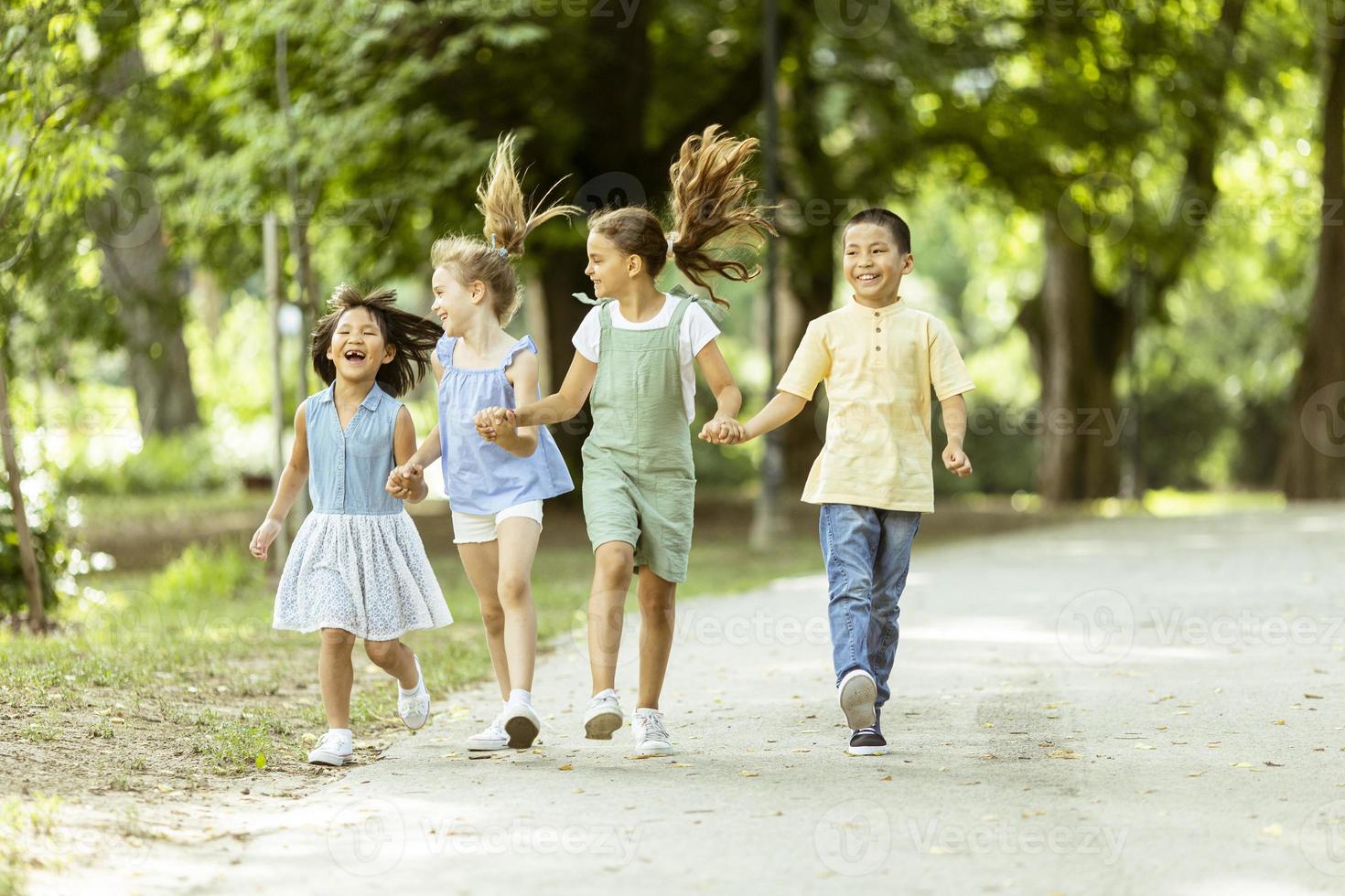 Group of asian and caucasian kids having fun in the park photo