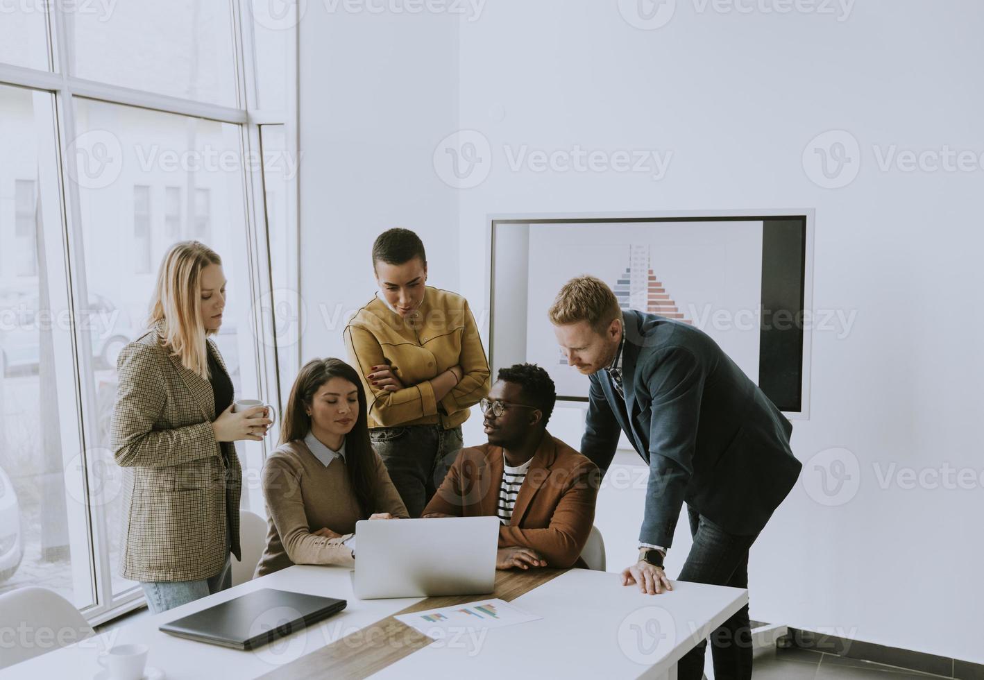 Group of multiethnic business people working together and preparing new project on a meeting in office photo