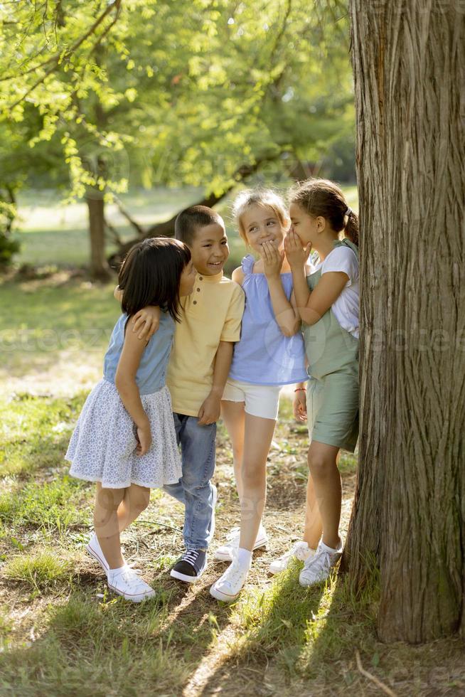 grupo de niños asiáticos y caucásicos divirtiéndose en el parque foto