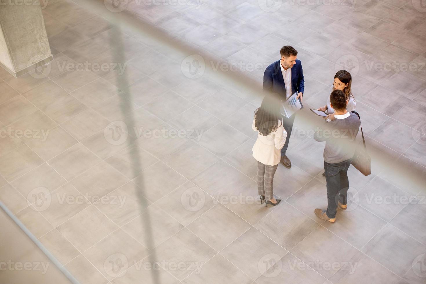 Aerial view at business people team discussing in the office hallway photo