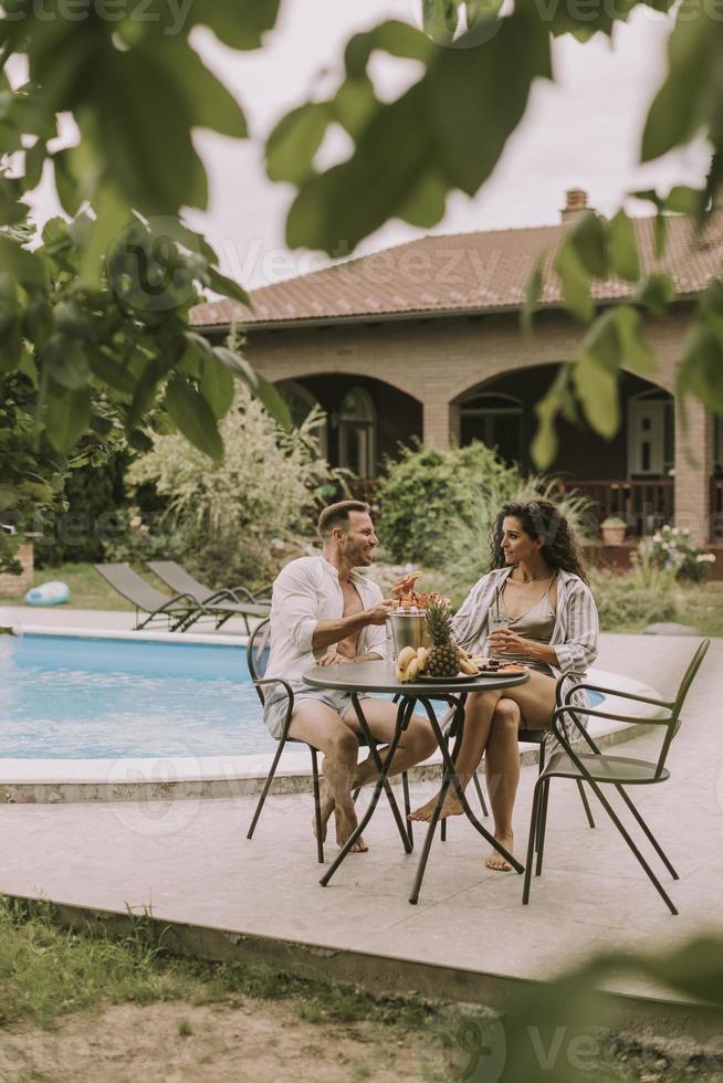 Young couple sitting in the backyard photo