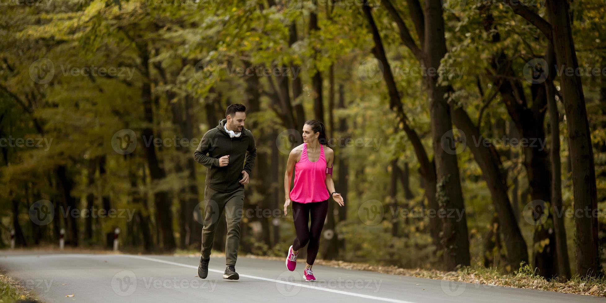 Young people jogging and exercising in nature photo