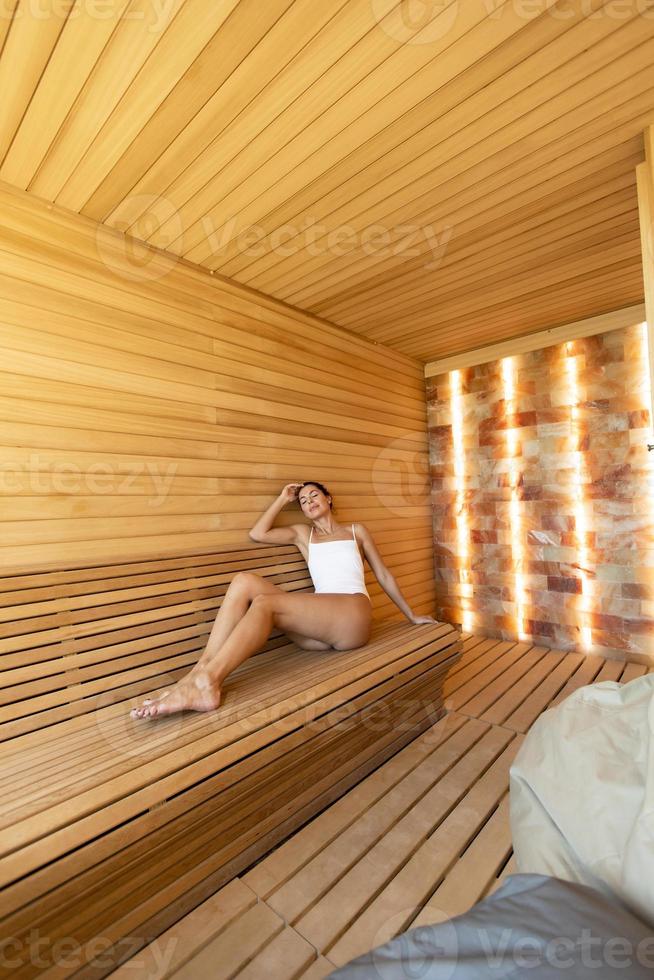 Young woman relaxing in the sauna photo