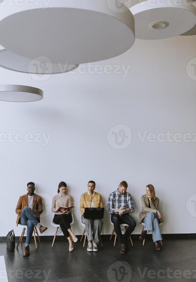 Group of bored people waiting for the job interview photo