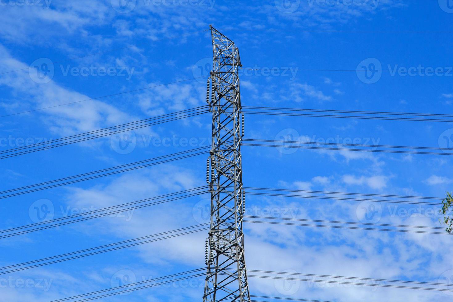 High voltage poles designed by engineers for industrial plants and consumer home power on blue and warm sky background is modern technology and modern industrial and dangerous, please do not approach. photo
