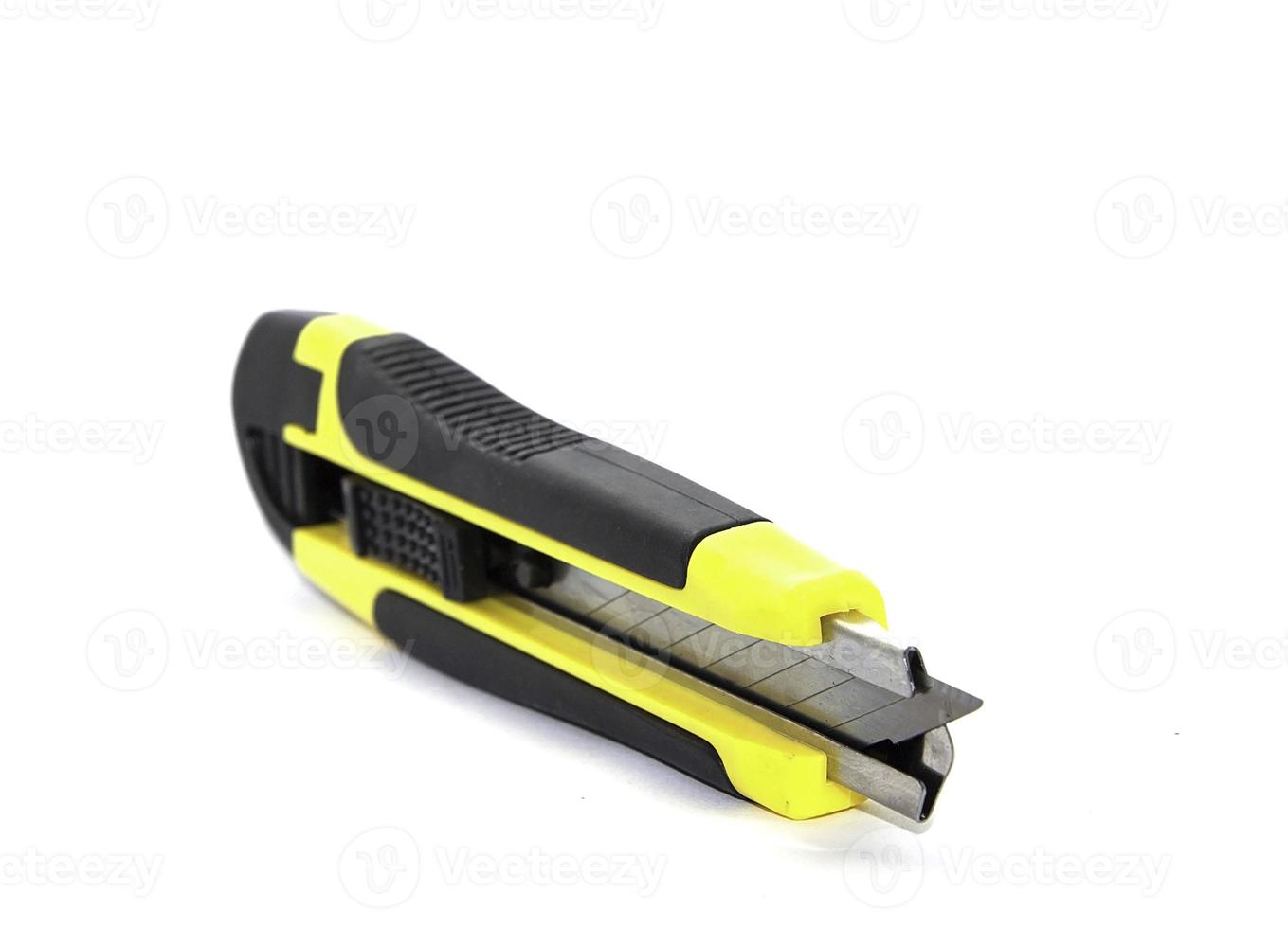 Yellow-Black Cutter Knife Office tools and technician equipment on a white background photo