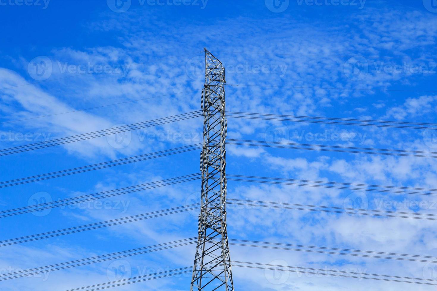 High voltage poles designed by engineers for industrial plants and consumer home power on blue and warm sky background is modern technology and modern industrial and dangerous, please do not approach. photo