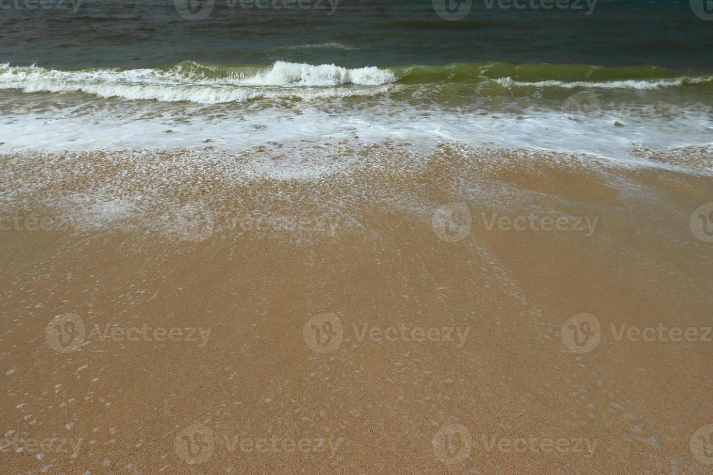Waves on shore of tropical beautiful sand beach on a sunny day photo