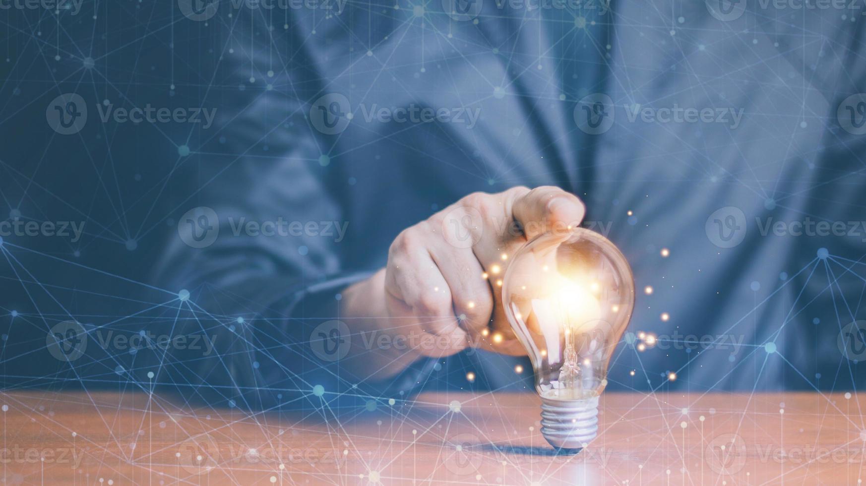 Businessman touching a bright light bulb. Concept of Ideas for presenting new ideas Great inspiration and innovation new beginning. photo