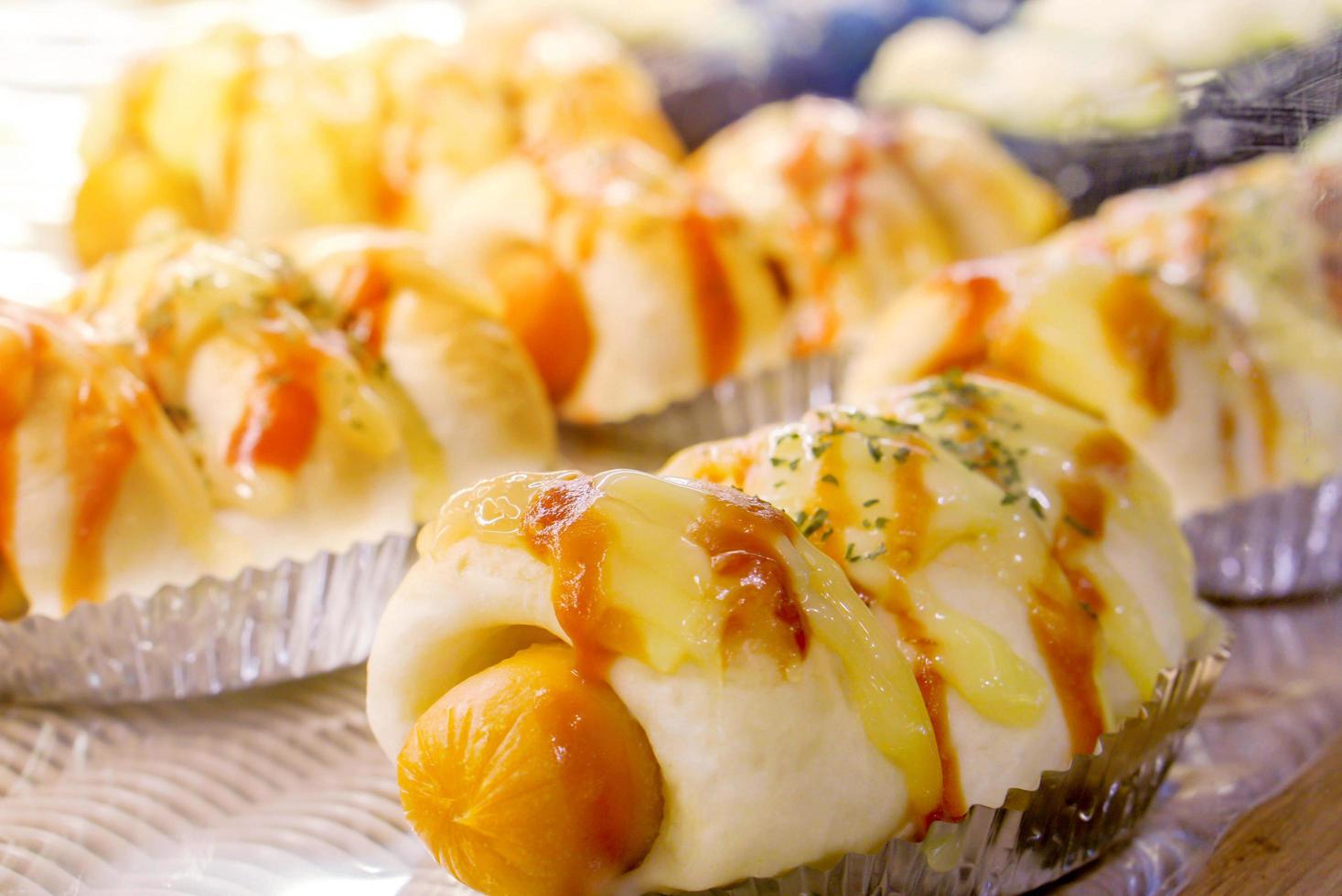 Close up and crop of sausage buns in bakery shop. photo