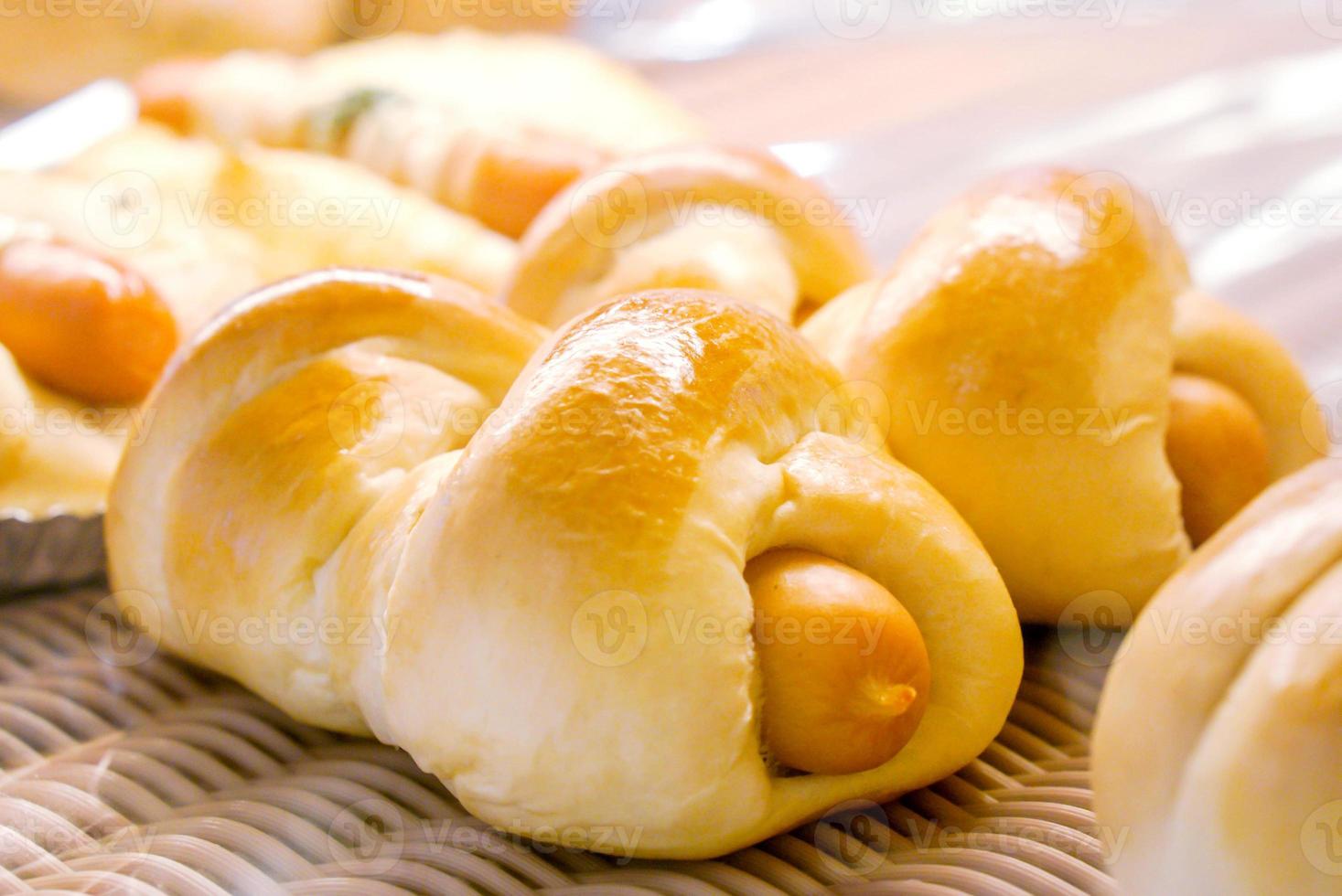 Close up of sausage buns in bakery shop. photo