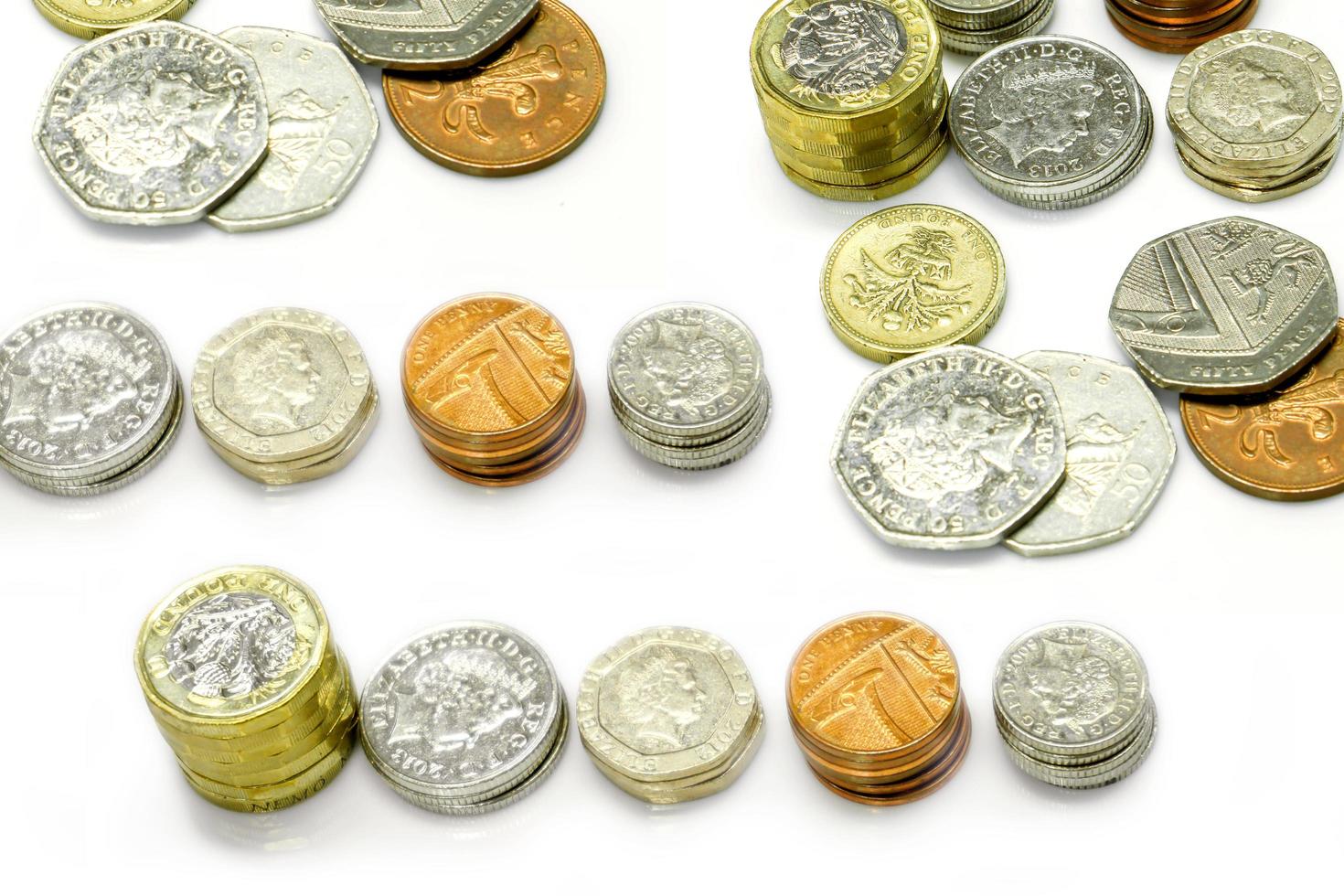 Top view of British currency coins as vertical and stack isolate on white background. photo