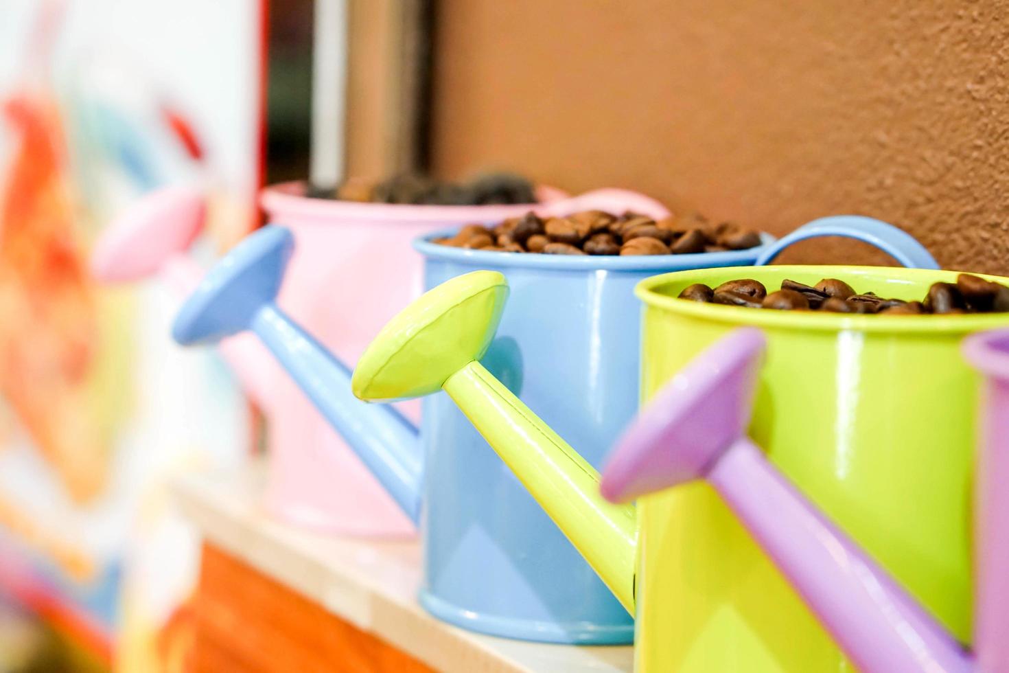 Closeup and crop Coffee bean in colorful small decoration shower pot. photo