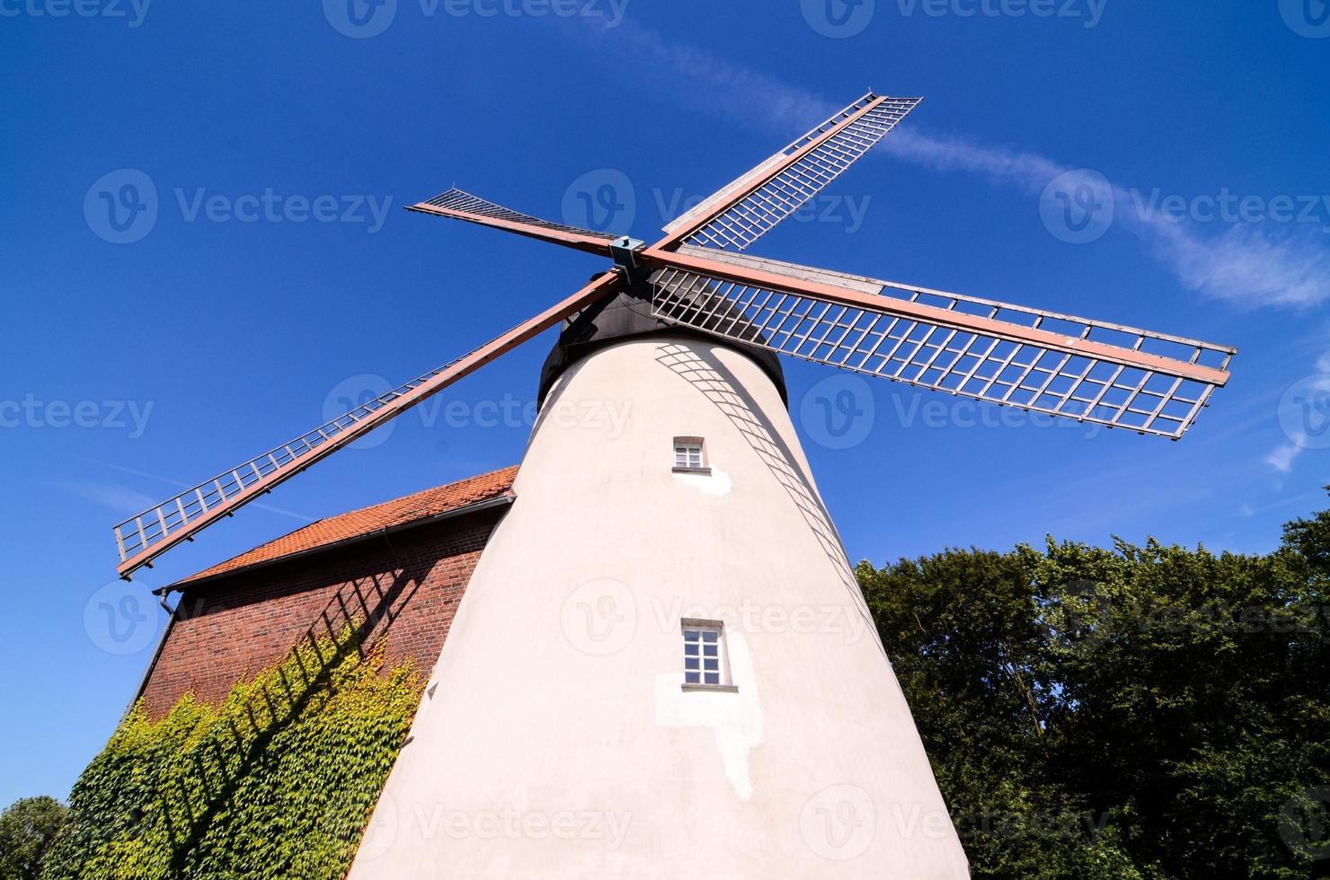 Traditional windmill under clear blue sky photo