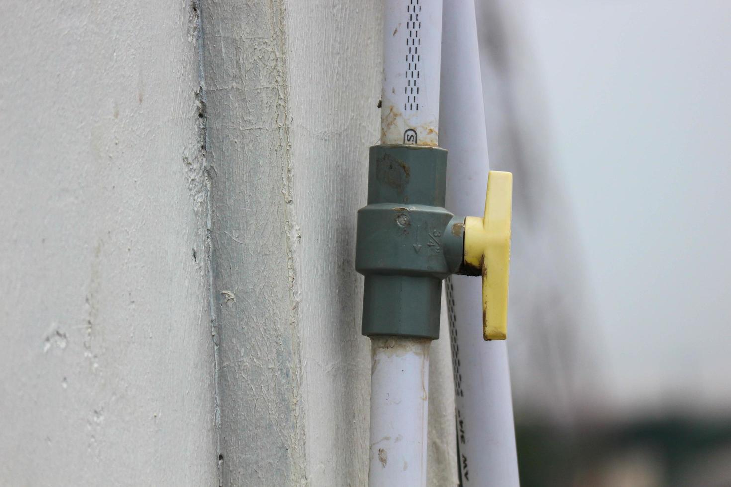 Valves or taps attached to pipes to open and close flow photo