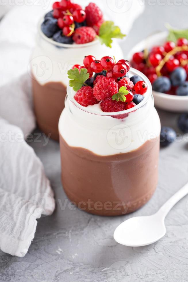 Chocolate pudding with cream and fresh berries photo