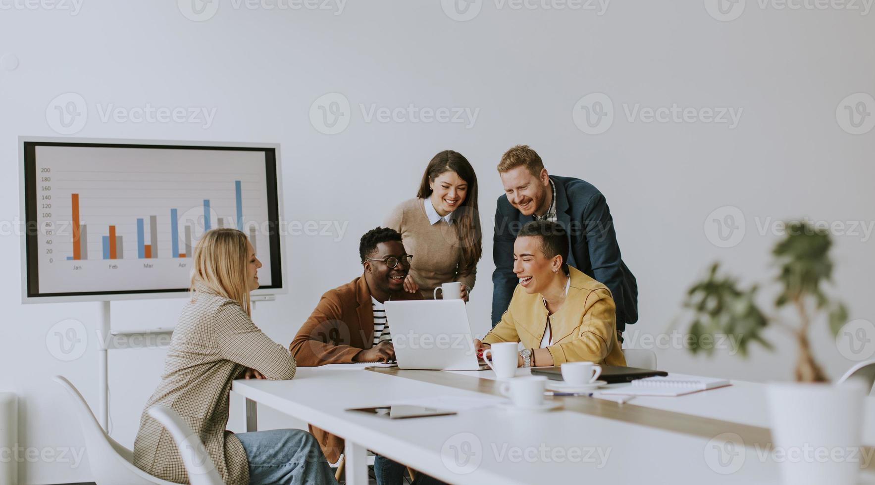 Group of multiethnic business people working together and preparing new project on a meeting in office photo