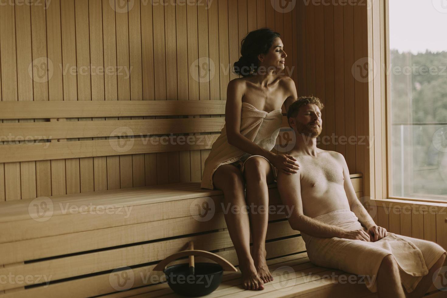 Young couple relaxing in the sauna photo
