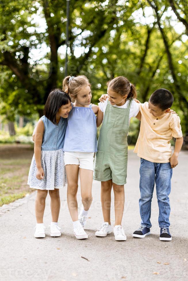 Group of asian and caucasian kids having fun in the park photo