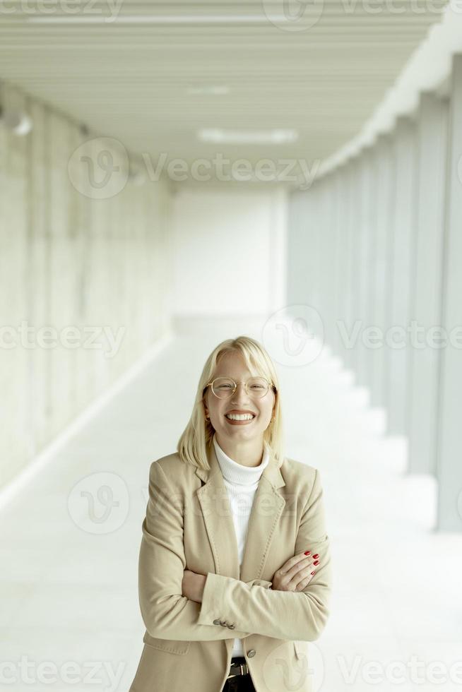 Business woman standing in the office corridor photo