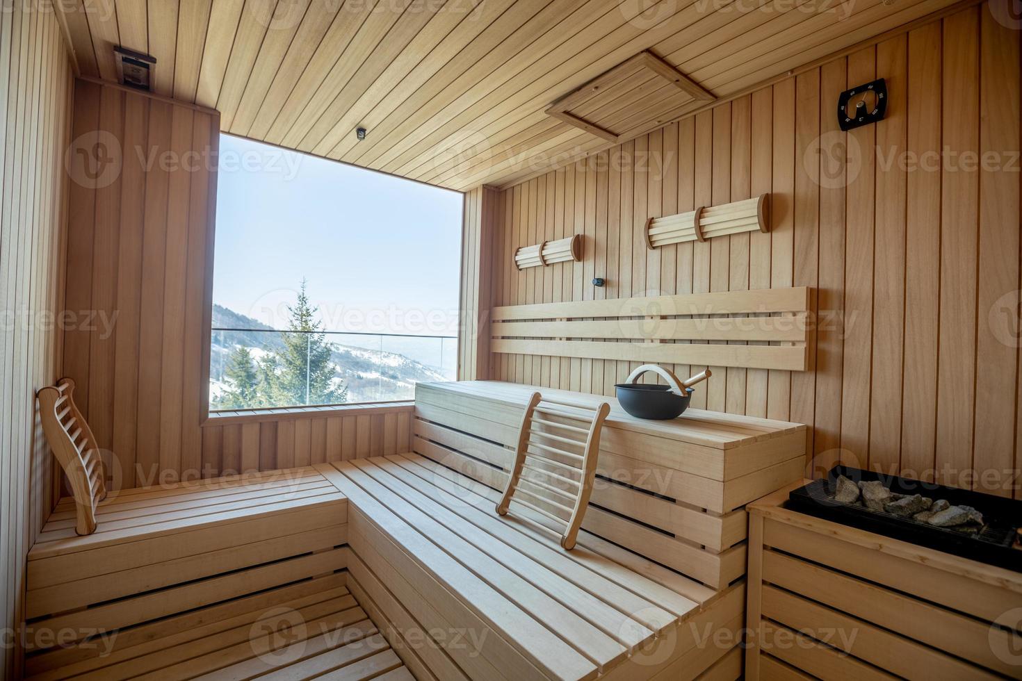 Empty wooden sauna room with traditional sauna accessories photo