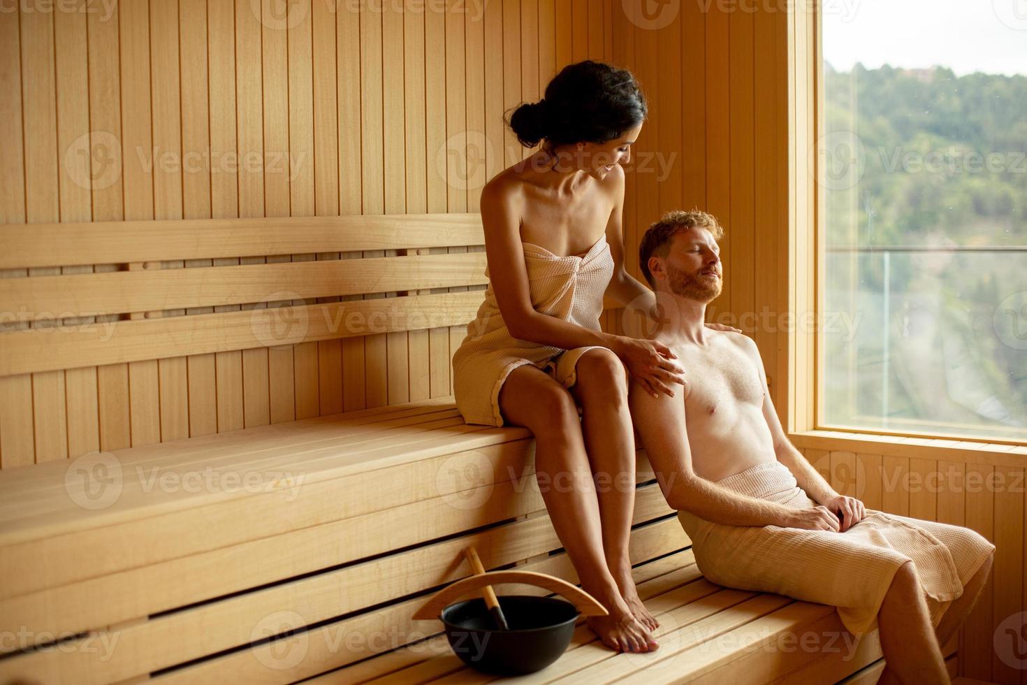 Young couple relaxing in the sauna photo